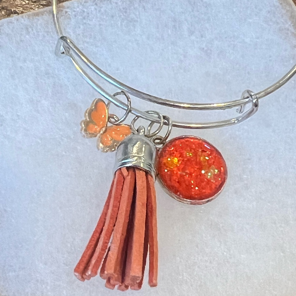 Silver and Orange Charm Bracelet with Tassel and Bow